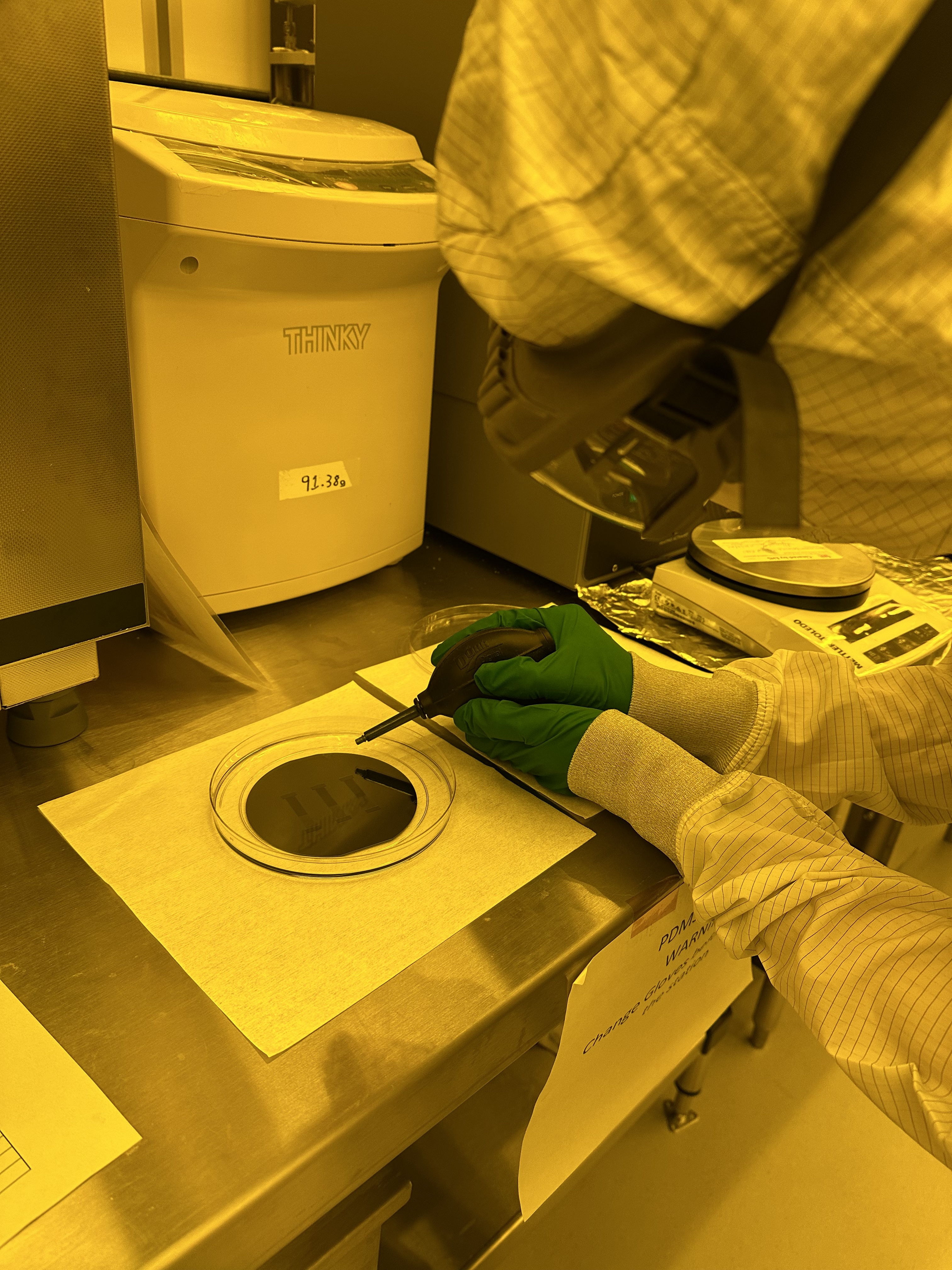 Researcher inspecting microfluidic chips at Princeton Materials Institute